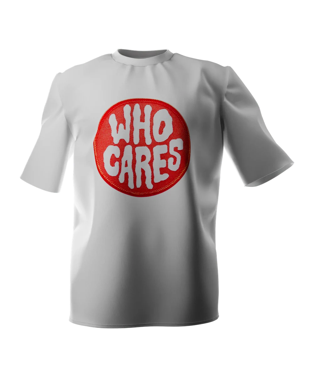White t-shirt seen from the front, printed across the chest with a round red embroidered patch reading WHO CARES in thick white stitched letters.